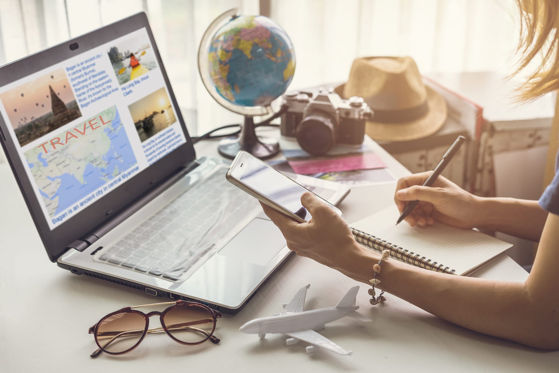 A woman at her computer planning her vacation trip.